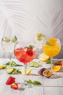 Cold sangria in wine glasses on white wooden table in morning sunlight