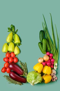 Composition with fresh vegetables on pale green background