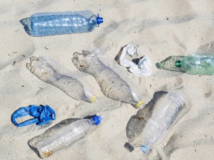 Empty plastic water bottles plastic bag sand