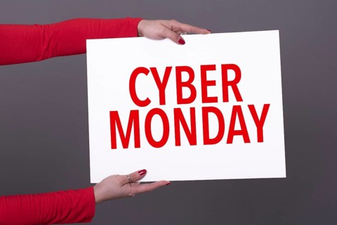 Female hands holding a cyber monday poster. Studio shot
