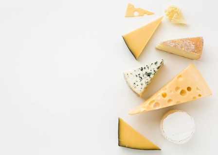 Flat lay assortment gourmet cheese with copy space