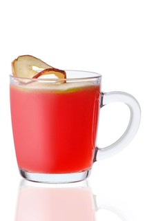 Glass of hot apple and cranberry drink isolated on white background