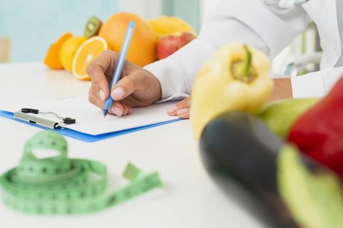 Close up nutritionist writing prescription