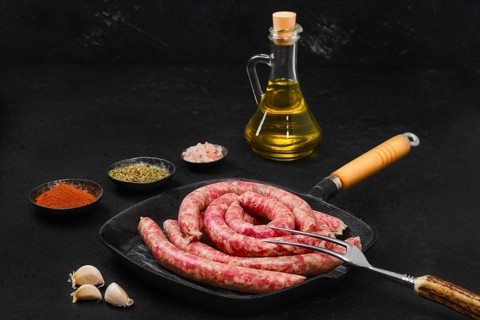 Thin beef sausages on grill pan