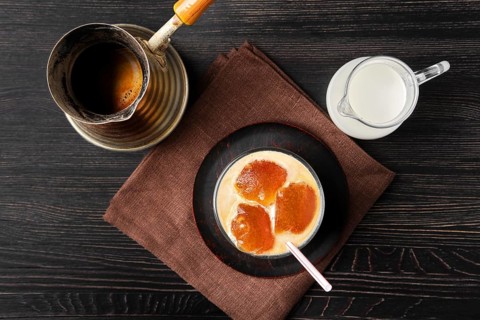 Top view of iced latte with frozen coffee cubes and sweet cream