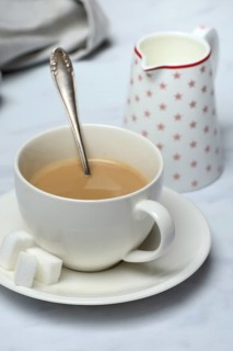 Cup of coffee and pot of milk