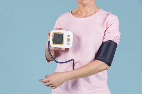 Woman showing results blood pressure electric tonometer screen. Resolution and high quality beautiful photo