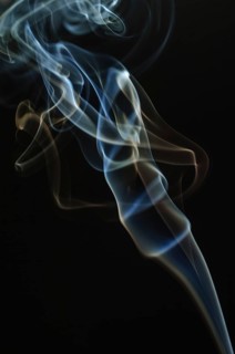Trajectory of incense smoke in the air showing different shapes. France