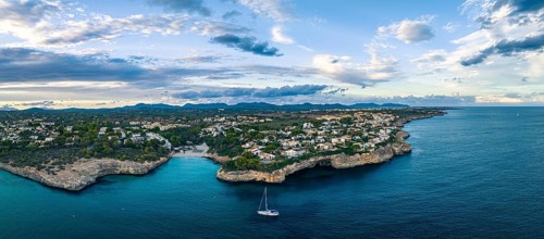 Sunset over Cala Anguila-Cala Mendia from a drone