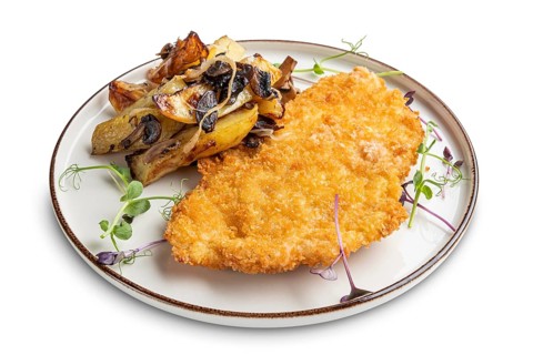 Tasty schnitzel in breading with fried potato