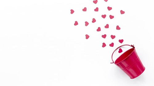 Flat lay bucket with hearts copy space