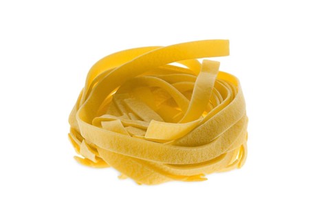 Nest noodles isolated on white background. Italian tagliatelle with egg