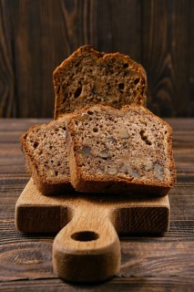 Closeup view of biscuit cake with walnut on wooden board