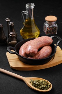 Homemade classic raw beef sausage in cast iron skillet