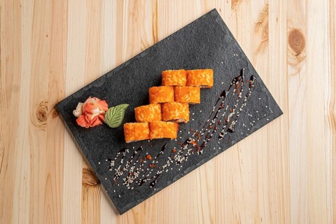 Set of rolls with wasabi and pickled ginger on stone serving board