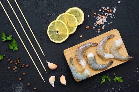 Overhead composition with fresh raw prawn with spice and herbs