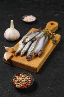Pile of fresh raw frozen capelin
