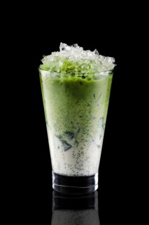 Iced matcha tea and crushed ice isolated on black background