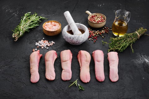 Composition with fresh raw lamb tongue with spice and herbs