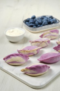 Frozen pierogi with blueberry and sour cream