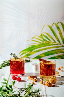Refreshing espresso and tonic summer drinks on white table under hard sulight