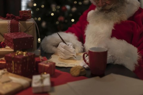 Close up santa claus writing letter