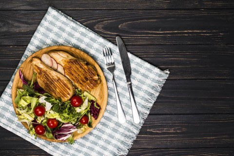 Utensils near roasted chicken and salad. Resolution and high quality beautiful photo