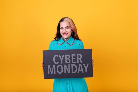 Beautiful woman holding a Cyber Monday sign. Commercial concept. Commerce