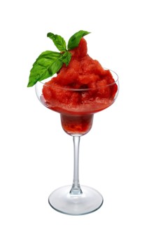 Watermelon smoothie in wide glass decorated with spinach leaves isolated on white