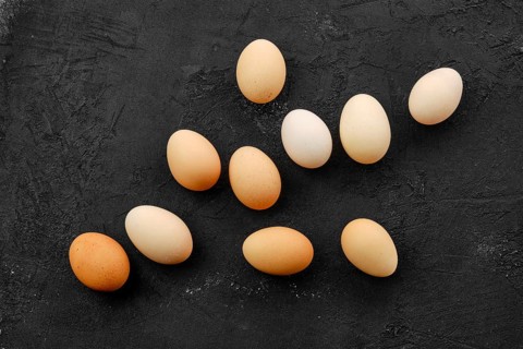 Fresh country eggs scattered on table