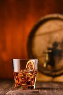 Cocktail old fashioned with barrel on background