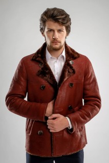Brutal handsome unshaven man with beard and moustache in sheepskin coat with fur collar