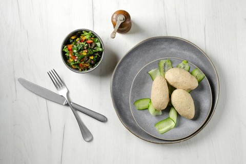 Top view of semifinished frozen cepelinai. Potato dumplings stuffed with ground meat