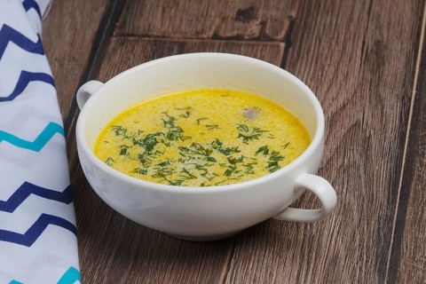Plate of mushroom soup on wooden table