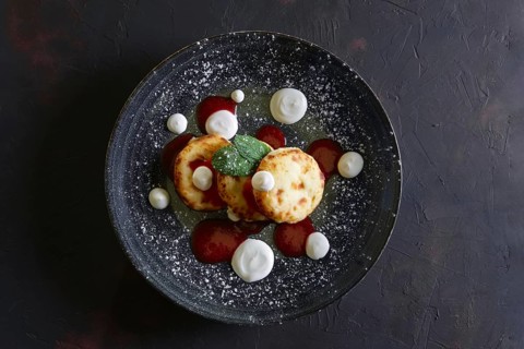 Cheese pancakes with sour cream and strawberry jam