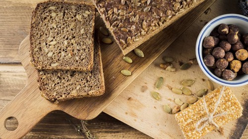 Healthy sunflower seed bread hazelnut bowl with protein bar chopping board