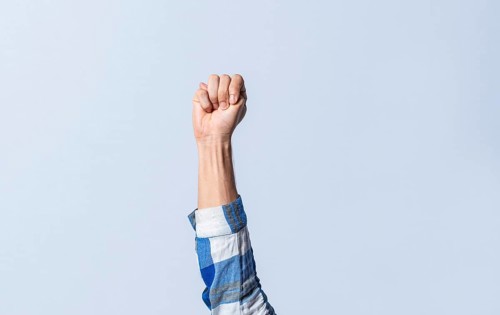 Hand gesturing the letter M in sign language on an isolated background. Man's hand gesturing the letter M of the alphabet isolated. Letter M of the alphabet in sign language