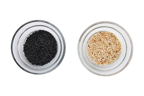 Top view of sesame seeds in a little bowls isolated on white background