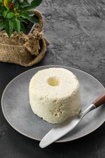 Pressed cottage curd cheese on ceramic plate