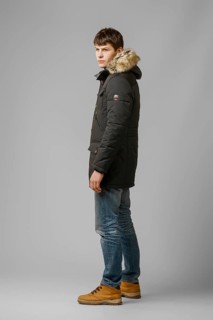 Full length portrait of handsome man in warm winter coat posing in studio