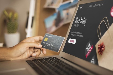 Hand holding card laptop mock up