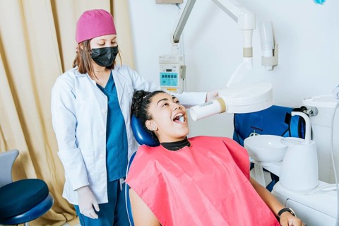 Dentist performing intraoral dental x-ray on a patient