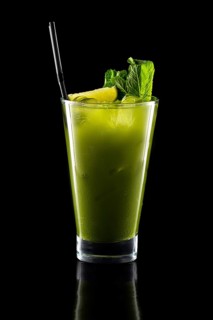 Glass of fresh cold smoothies with straw isolated on black background