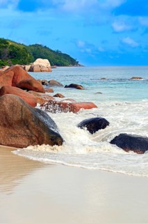 Beach and rocks of Anse Lazio in the evening