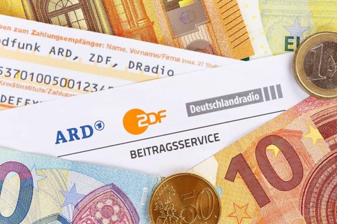 Contribution service of ARD and ZDF Rundfunkgebuehr GEZ with money in Stuttgart