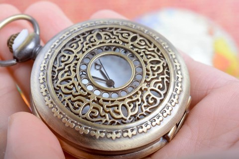 Man holding a retro styled Pocket watch in hand
