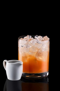 Espresso tonic with sea buckthorn syrup isolated on black background