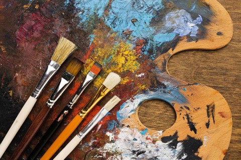 Front view dirty color palette with brushes