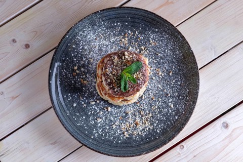 Fritters with peanut butter. Traditional Slavic pancakes with chocolate paste