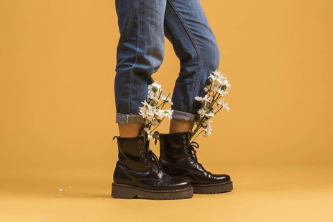 Woman legs wearing boots with flowers inside. Resolution and high quality beautiful photo